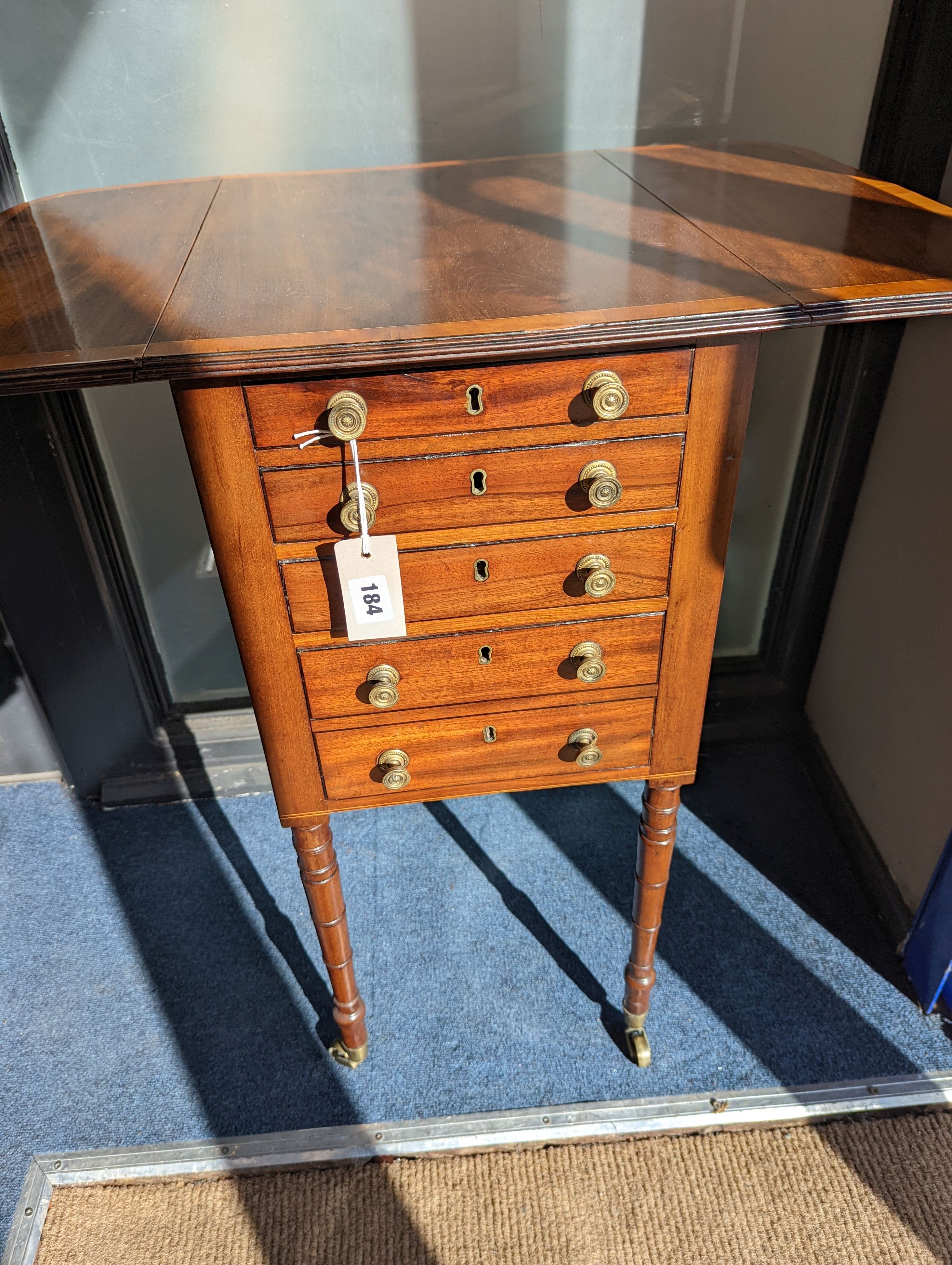 A Regency satinwood banded mahogany drop flap work table, width 69cm extended, depth 46cm, height 76cm